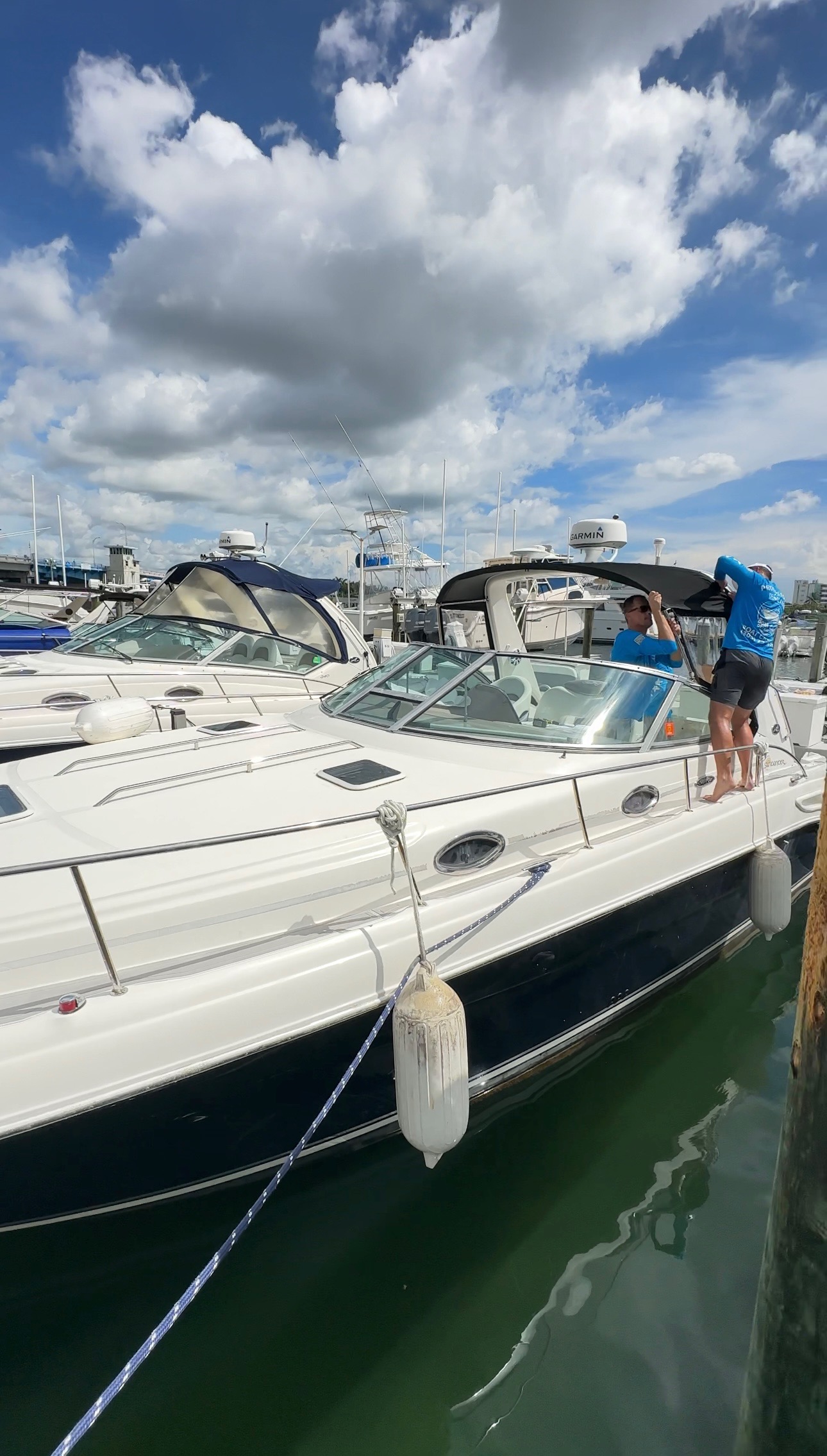 BoatCare360 team at premium marina with dramatic clouds and clear water
